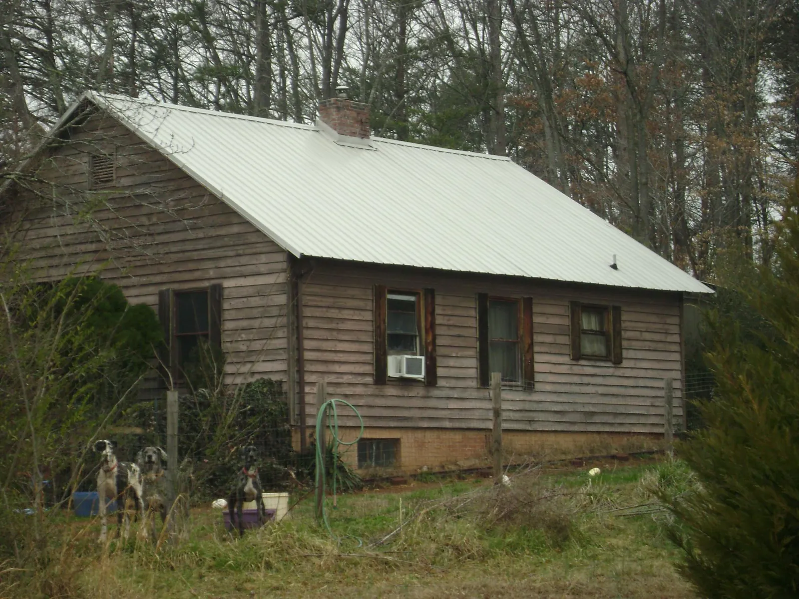 White metal roof on an old wood sided farmhouse, from a Metal Roof Installation job in Aspinwall